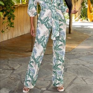 Unworn jumpsuit from Club L London bold tropical print and elongating wide legs.